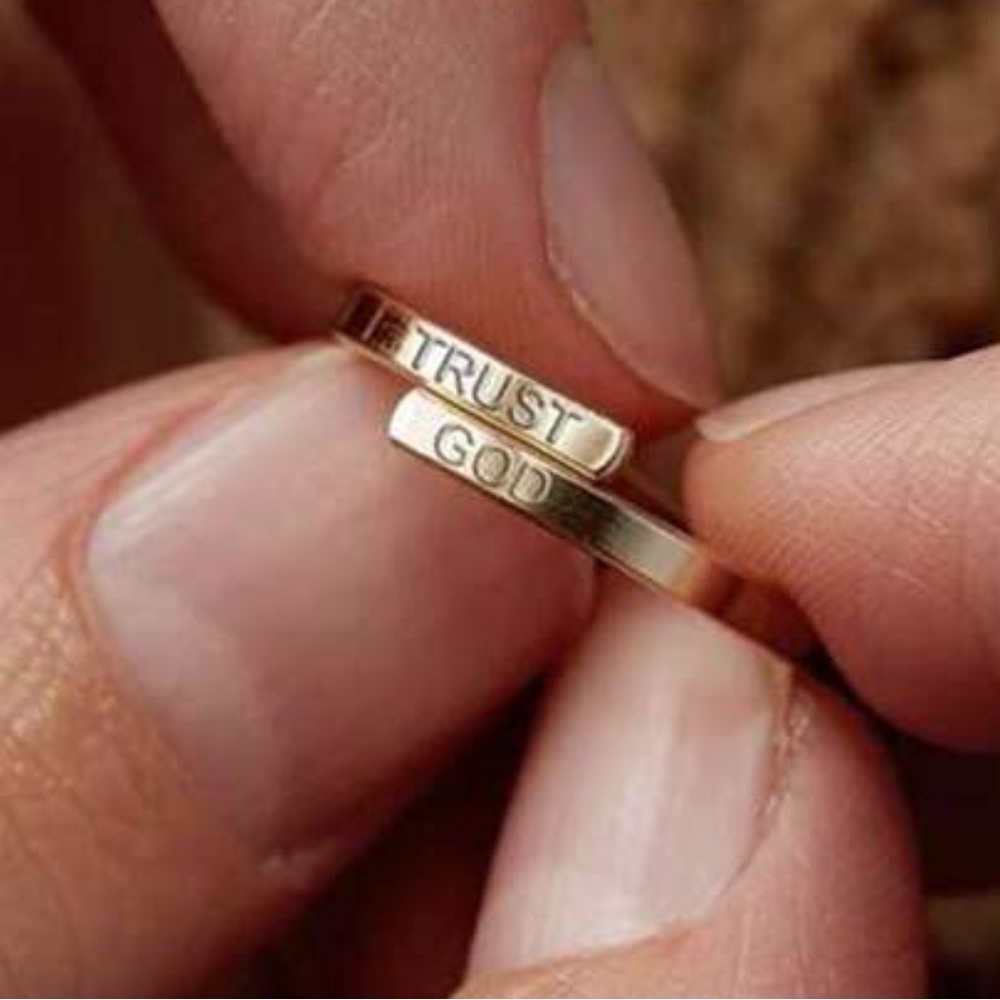 ring engraved with 'Trust' and 'God'
